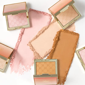 Jouer powder on vanity beside makeup for easy everyday radiance benefit