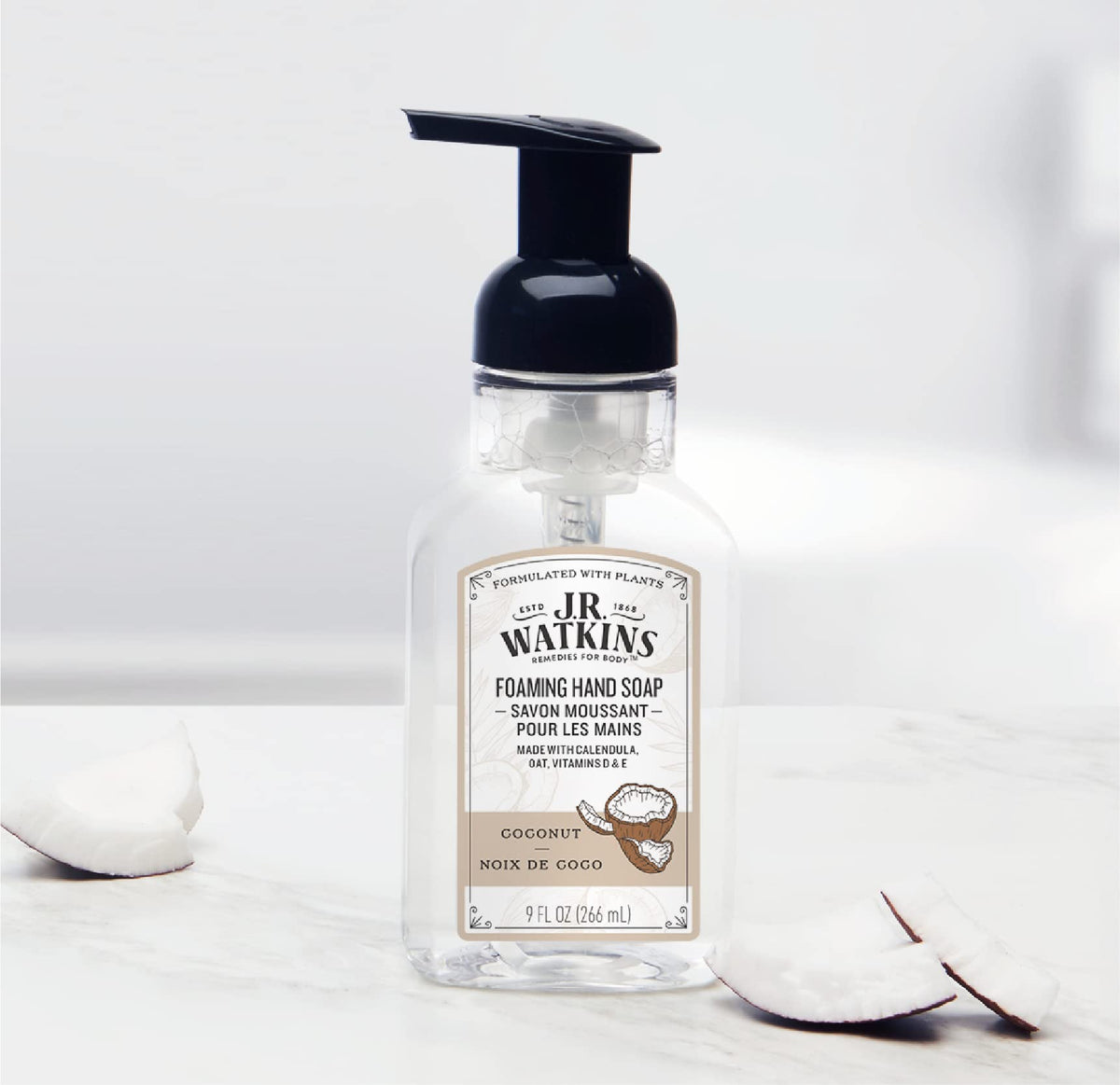 J.R. Watkins bottle next to a hand showing 9 fl oz size and portability benefit