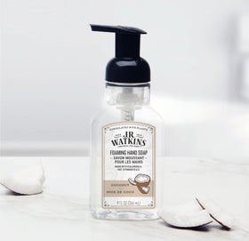 J.R. Watkins bottle next to a hand showing 9 fl oz size and portability benefit