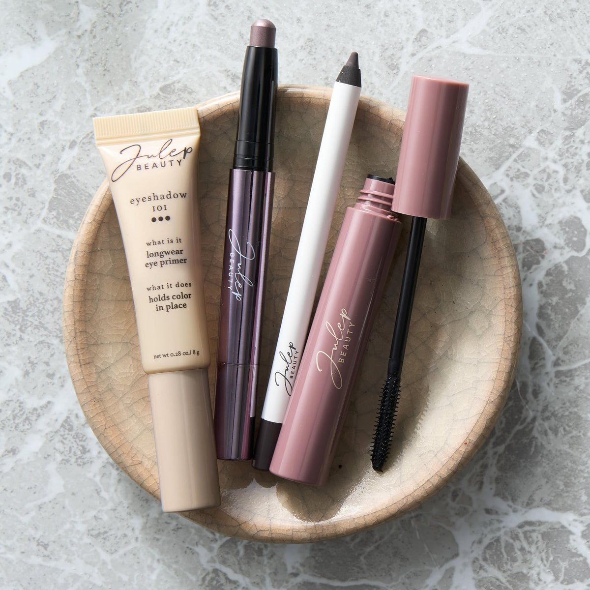 Julep stick next to coin showing compact size for easy travel