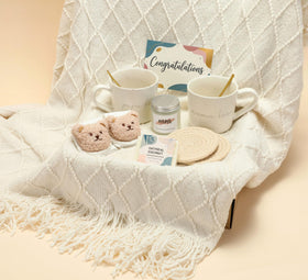 JW Passion newborn bear socks beside ruler for scale, cute protective feet layer
