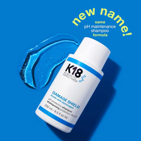 K18 bottle held in hand showing 16 fl oz size and scale