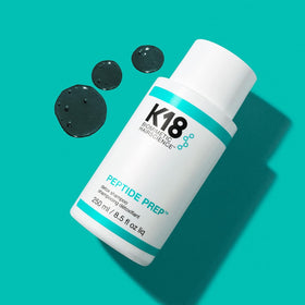 K18 16 fl oz bottle beside common objects to show actual product size