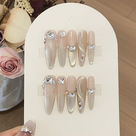 Kaipheiquan crystals on finished nails in lifestyle setting, showcasing dazzling effect