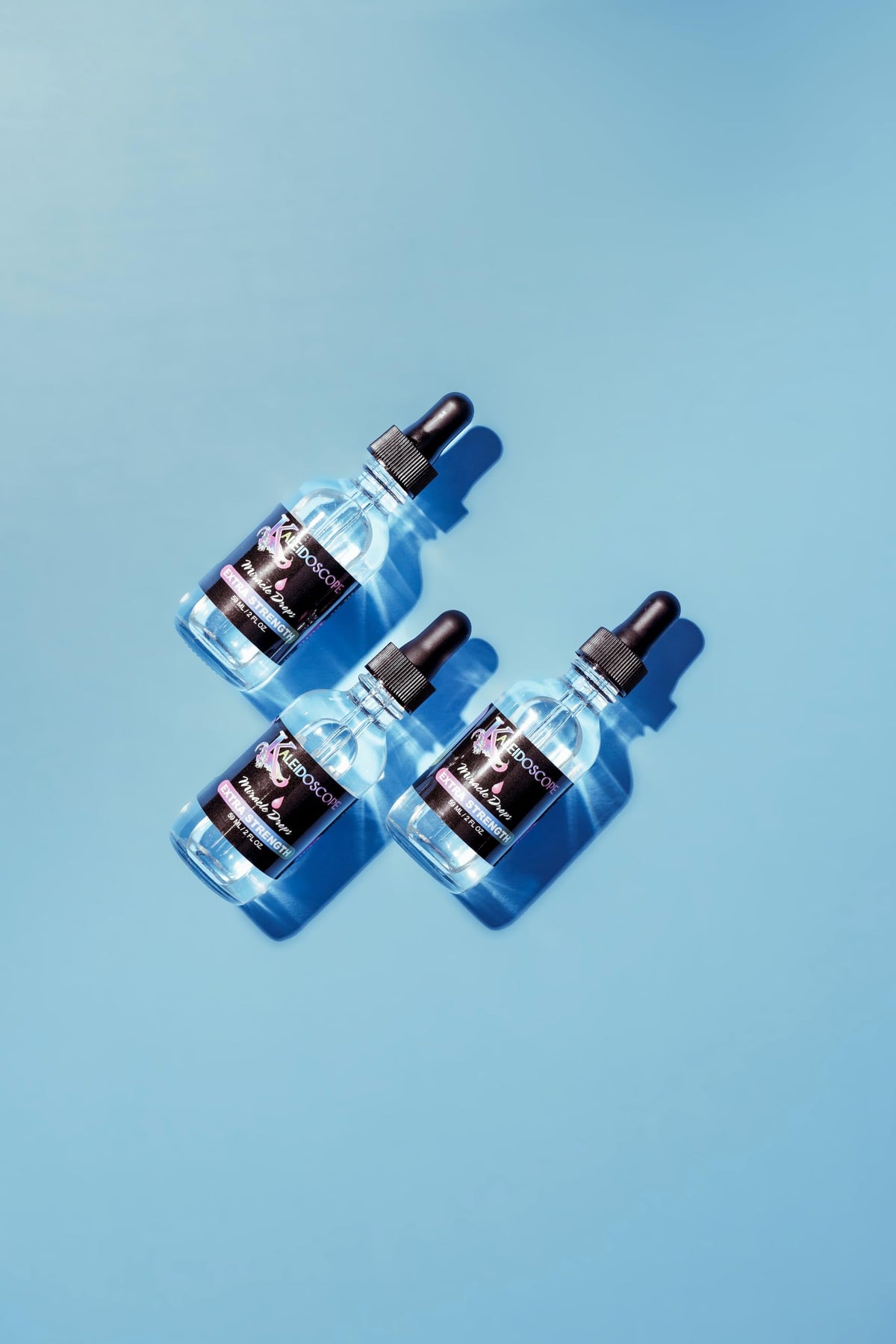 Kaleidoscope Hair Products dropper releasing oil to show lightweight texture and easy application