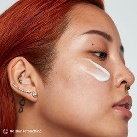 Kate Somerville applying cream to face illustrating soothing relief and dewy finish benefit
