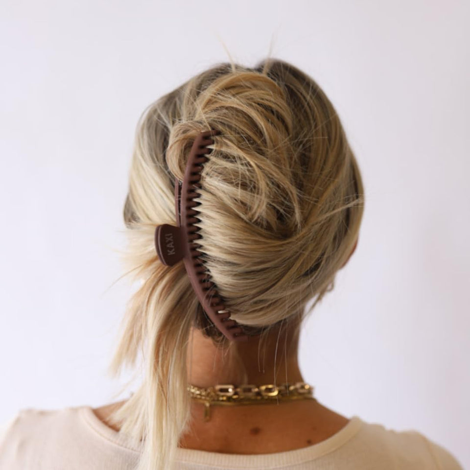 KAXI front profile dark brown clip showing sleek silhouette and reliable hold