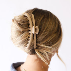 KAXI holding a half-up wavy hairstyle for polished casual looks