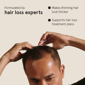 Keeps pomade being rubbed between hands demonstrating warm-up for application