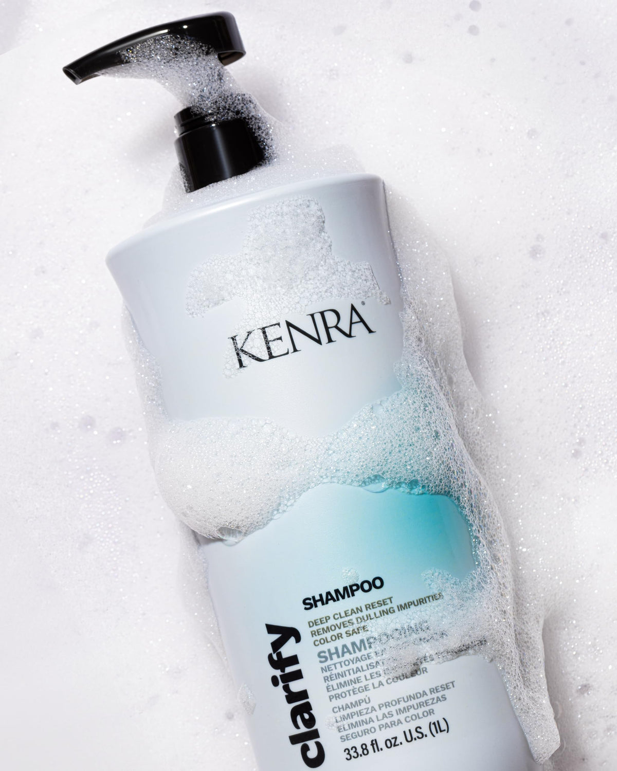 Kenra 33.8 fl oz bottle next to a ruler showing professional-size value