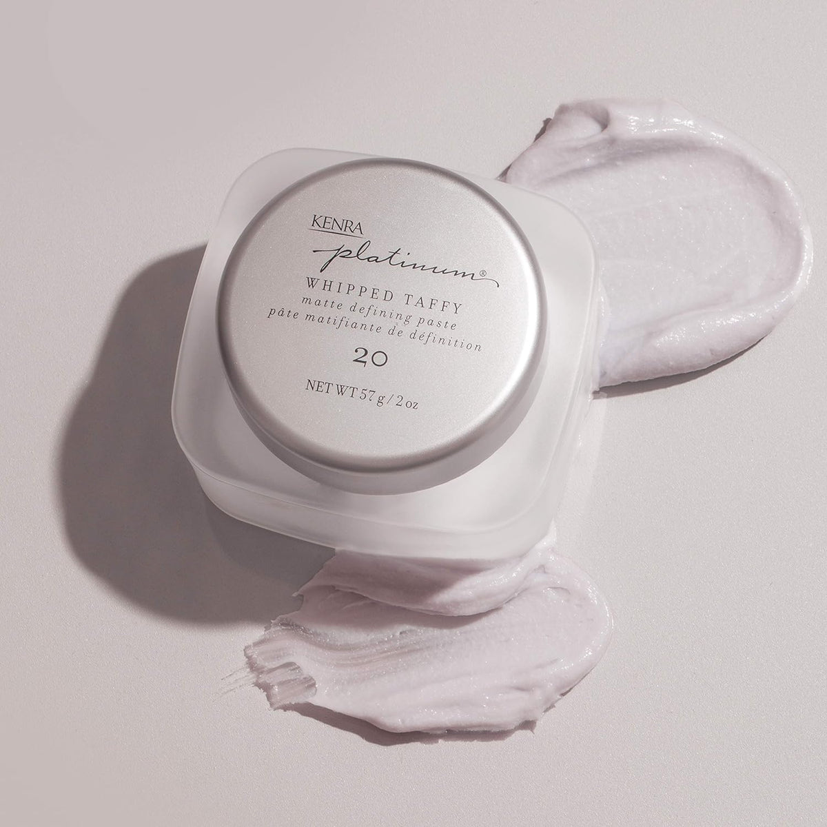 Kenra in-hand application showing paste spread on palm for easy styling