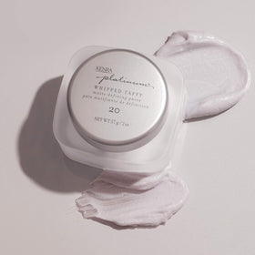 Kenra in-hand application showing paste spread on palm for easy styling