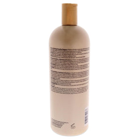 KeraCare shampoo poured into hand showing creamy texture and easy detangling