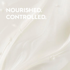Kerasilk shampoo in hand showing 250ml scale and travel-friendly convenience