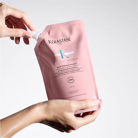KÉRASTASE lifestyle shot of scalp care routine demonstrating soothing benefit