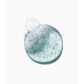 KÉRASTASE Genesis Homme rinsing shampoo with water droplets to emphasize clean rinse