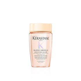 KÉRASTASE front packaging travel bottle shows brand and glossy benefit