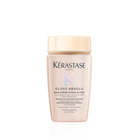 KÉRASTASE travel bottle front view showing brand and glossy packaging benefit