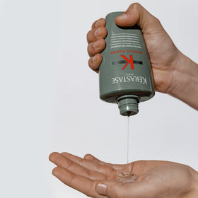 KÉRASTASE bottle next to razor showing size and travel-friendly scale