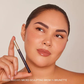 Kevyn Aucoin model applying pen to brows for easy, accurate application