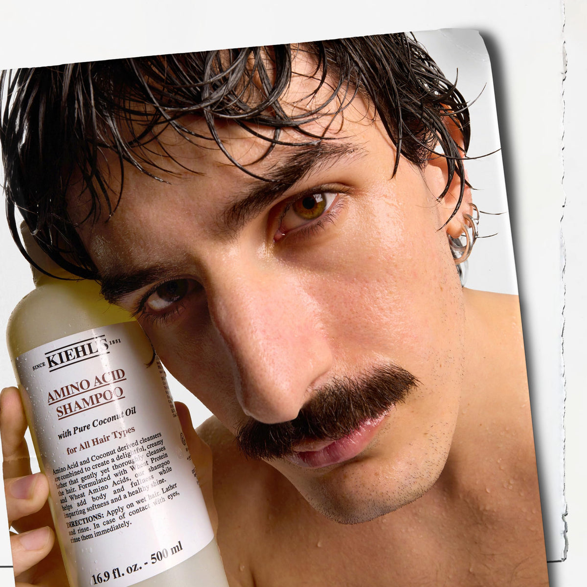 Kiehl's model with glossy hair after wash showing softness and shine benefit