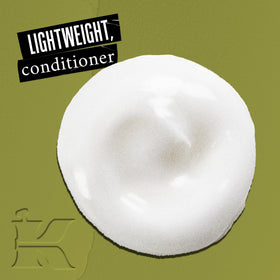 Kiehl's close-up of conditioner texture highlighting silky consistency for easy detangling