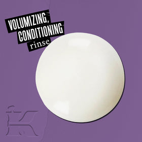 Kiehl's conditioner texture on hand illustrating lightweight, spreadable formula benefit