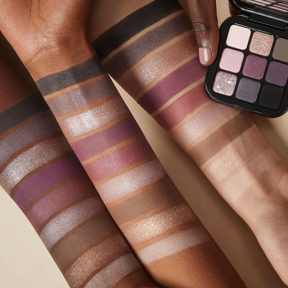 Kiko Milano palette beside makeup brush showing compact size and travel-friendly mirror