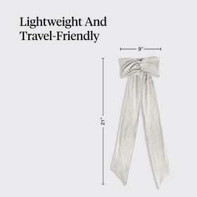 Kitsch headband next to a hand showing size and portability benefit