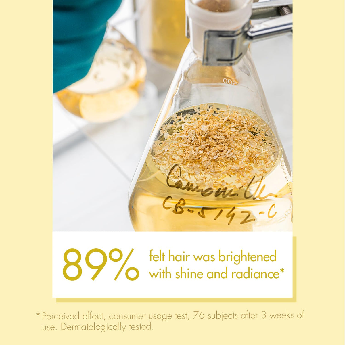 Klorane shampoo held in hand for scale illustrating portable 13.5 fl oz convenience benefit