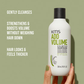 KMS AddVolume bottle next to hand for scale emphasizing salon-size 750ml value