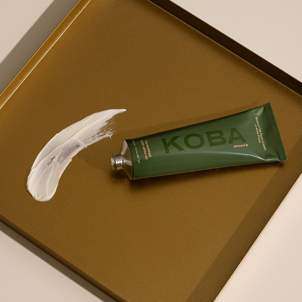 KOBA cream massaged into heels showing smoothing and softening benefit