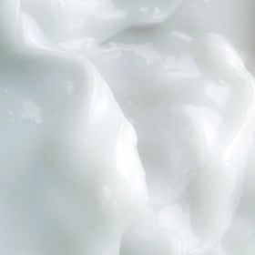 KORA Organics open jar revealing creamy texture, highlights hydrating, non-greasy feel