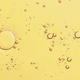 KORA Organics dropper dispensing oil to show silky lightweight texture