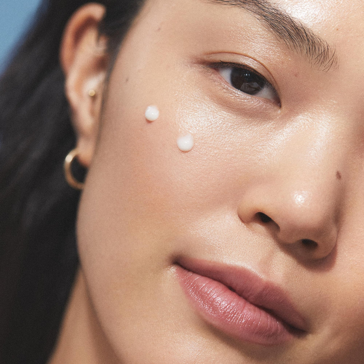 KORA Organics serum drop on fingers demonstrating easy application and hydration
