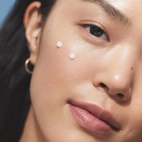 KORA Organics serum drop on fingers demonstrating easy application and hydration
