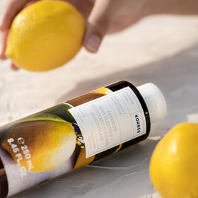 KORRES bottle in shower setting illustrating refreshing basil lemon sensory benefit