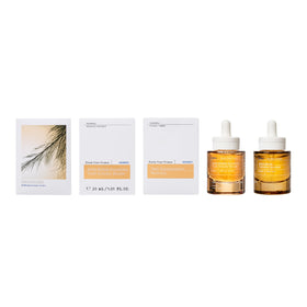 KORRES bottle set against pine branches evoking antioxidant-rich forest benefit