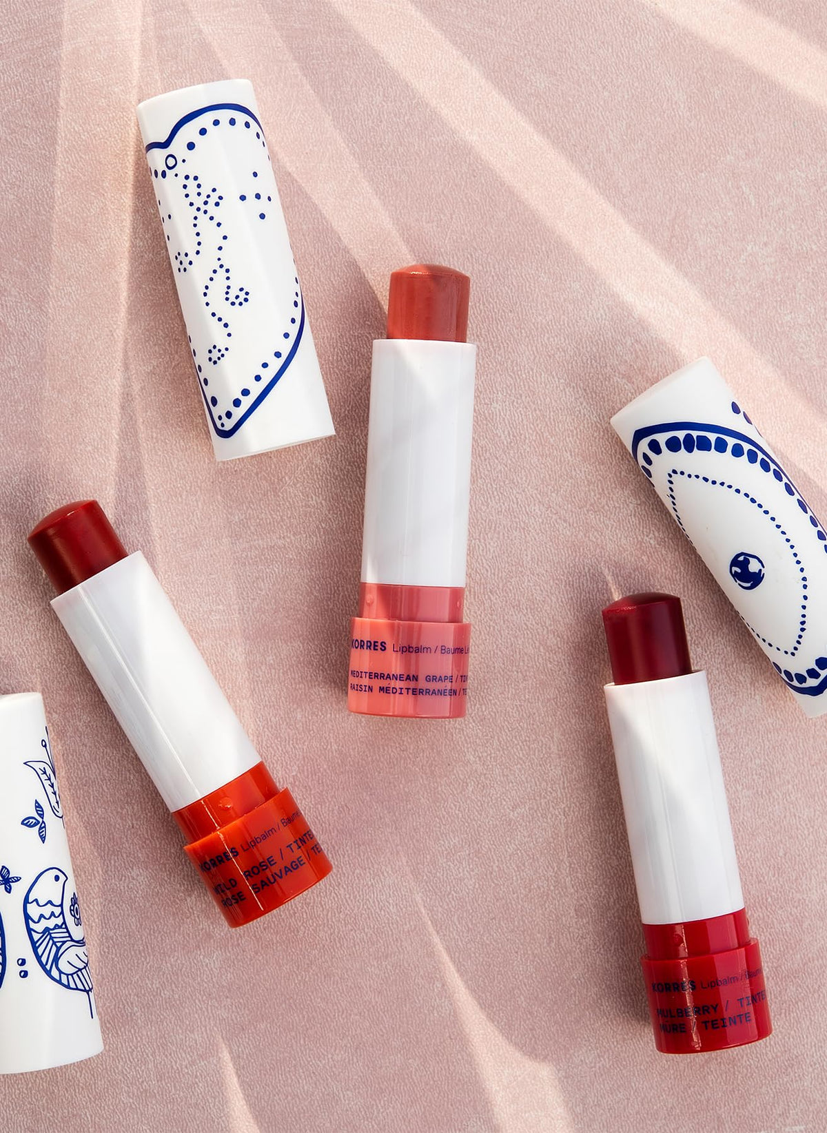 KORRES lip butter in use on lips demonstrating sheer mulberry color