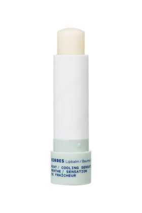 KORRES lip butter stick in hand illustrating size and portability for on-the-go hydration benefit