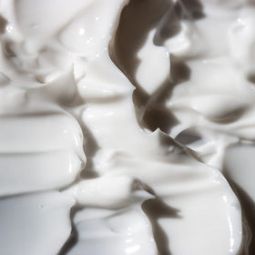 KORRES cream being applied to arm showing smooth, moisturized skin
