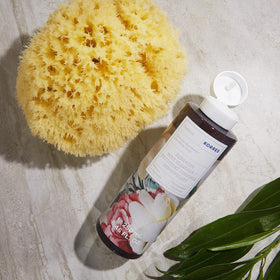 KORRES lifestyle image of product in shower setting demonstrating hydrating, spa-like ritual