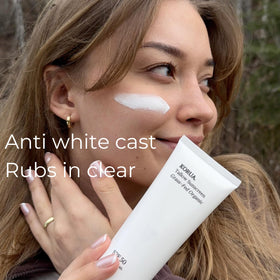 KORUA applying sunscreen on hand demonstrating easy spreadability