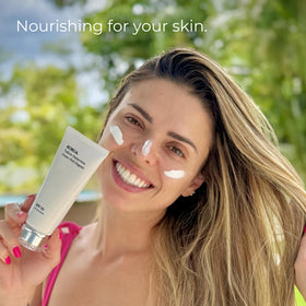 KORUA lifestyle on beach showing reef-safe sunscreen in use