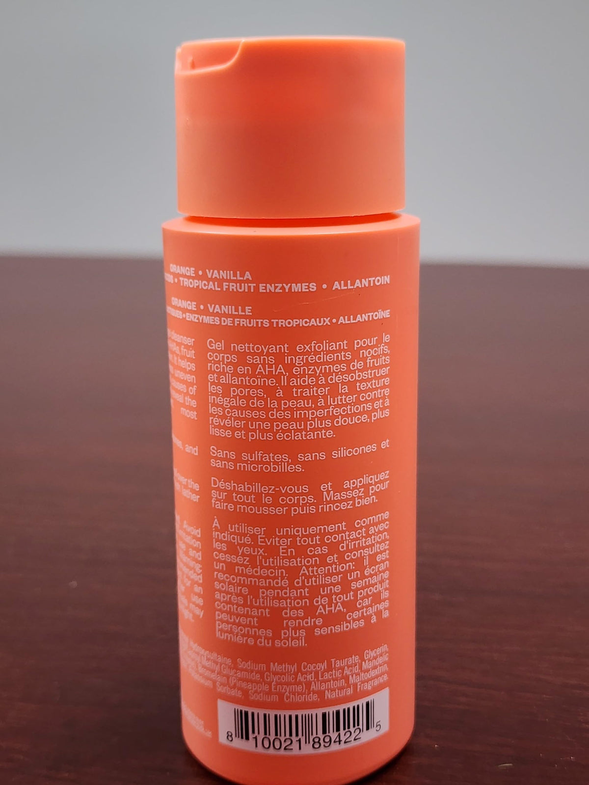 Kosas bottle held in hand for scale and travel-friendly size