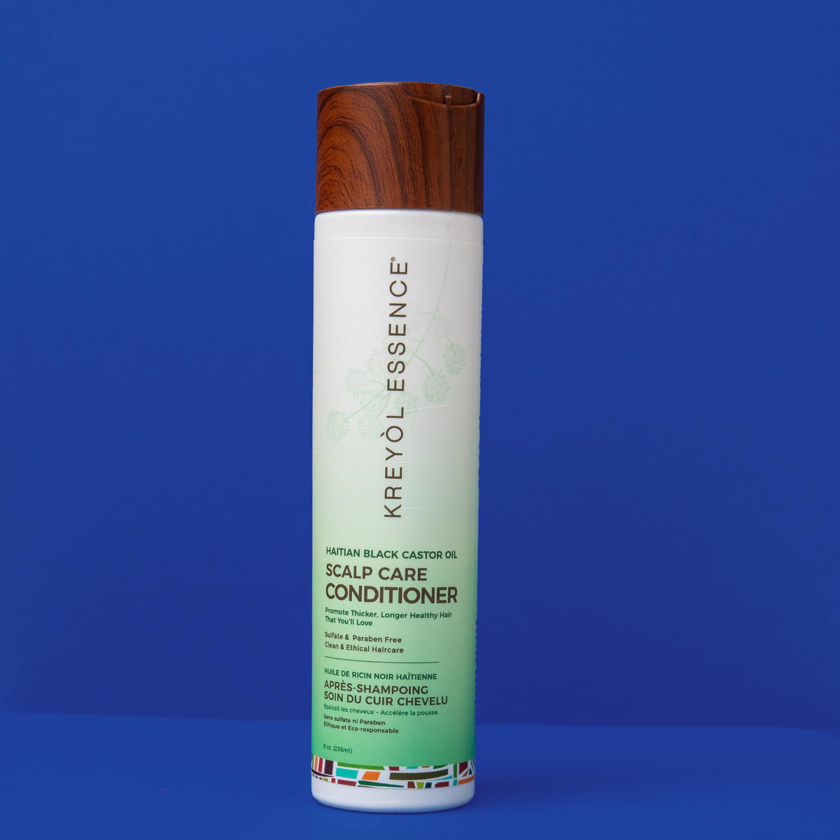Kreyol Essence paired with Haitian black castor oil bottle to show complementary use