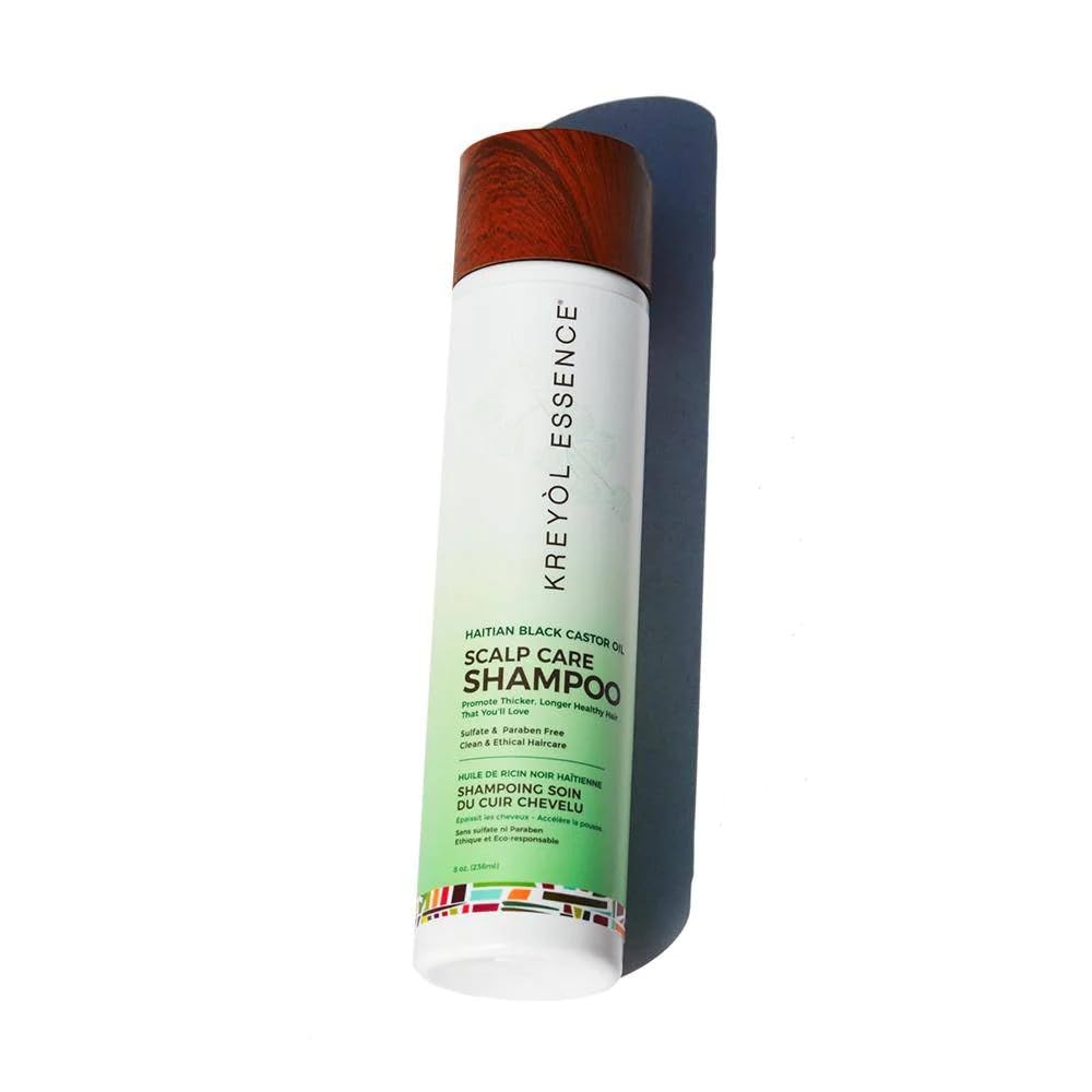 KREYÒL ESSENCE close-up Haitian Black Castor Oil bottle and botanical benefit