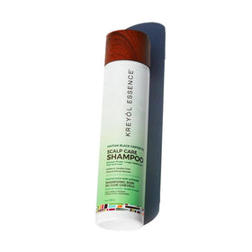 KREYÒL ESSENCE close-up Haitian Black Castor Oil bottle and botanical benefit
