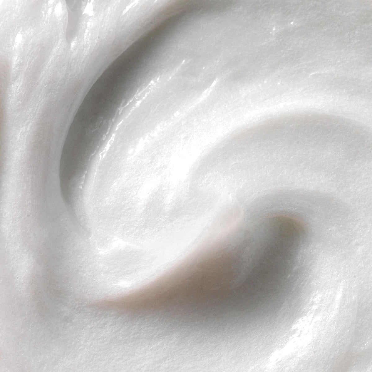 Kristin Ess conditioner creamy texture on palm for slip and hydration during detangling