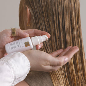 Kristin Ess working serum bottle close-up highlighting the pump
